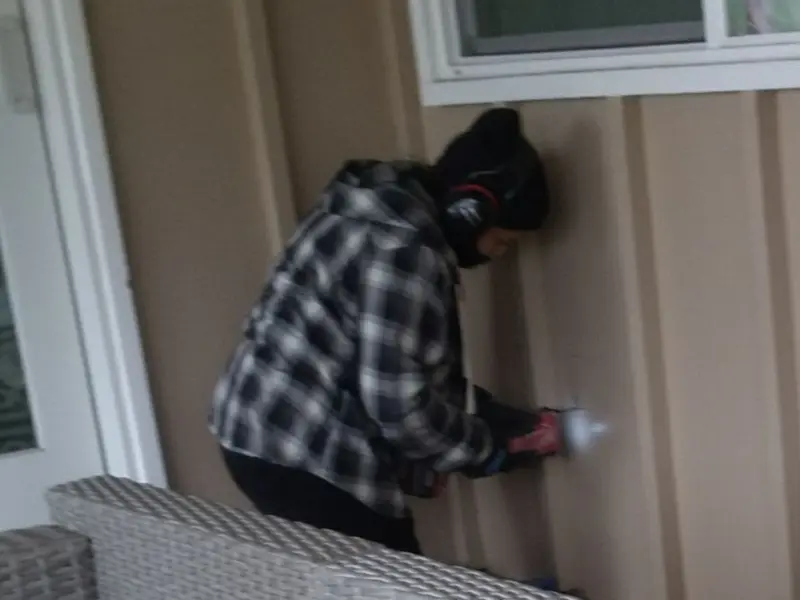 Professional electrician installing an exterior outlet in Des Moines